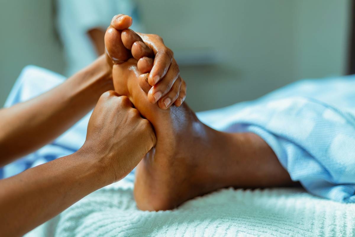 cms routine foot care guidelines illustrated with a person applying a hydrating foot mask at home